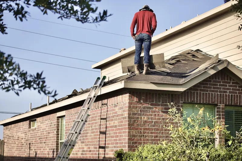 Professional roofer working on a residential roof in Gulf Pines